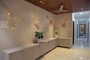 an office with a waiting room with plants on the wall at Yendluri's- QueenBed Room-25 Kondapur, Gachibowli in Lingampalli