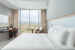 Postel nebo postele na pokoji v ubytování Hotel Local Dubai at Jumeirah Village Triangle