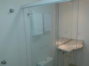 a bathroom with a shower and a sink and a toilet at Apartamento no 20 piso com 90m2 e linda vista in Torres +33 photos