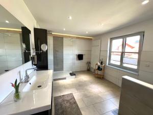 a large bathroom with a sink and a shower at Balance Apartments by M&A - Family Apartment Ferienhaus Dohrenbach in Witzenhausen +10 photos