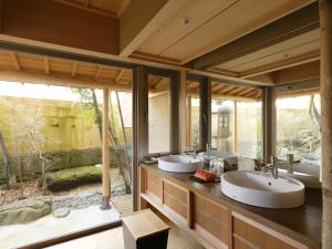 a bathroom with three sinks and a large window at Kinjohro in Kanazawa