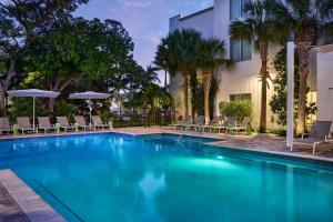 a swimming pool with chairs and a building at Faro Blanco Resort & Yacht Club Marathon, Curio by Hilton in Marathon