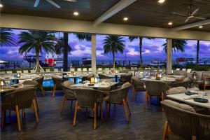 a restaurant with tables and chairs and a view of the ocean at Faro Blanco Resort & Yacht Club Marathon, Curio by Hilton in Marathon