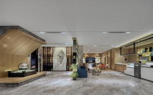 a lobby of a building with a lobby at Echarm International Hotel Pazhou Convention and Exhibition Center Nanzhou Metro Station Branch - Free Shuttle Bus to Canton Fair Complex During Canton Fair Period in Guangzhou