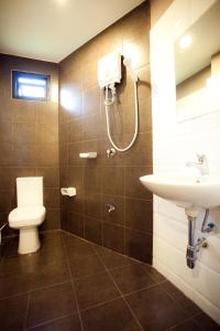 a bathroom with a toilet and a sink at Khaosan Park Resort in Bangkok