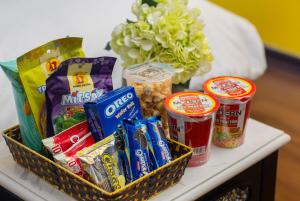a table with a basket of snacks and a vase of flowers at Royal Hotel Vinh Yen in Nhân Mỹ