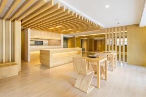 a kitchen with wooden counters and tables in a room at Zenniq in Bangkok