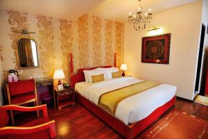 a bedroom with a large bed and a chandelier at Mandala Boutique Hotel in Kathmandu +25 photos