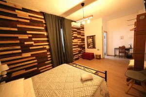 A bed or beds in a room at Camurria Sicilian B&B