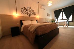 A bed or beds in a room at Camurria Sicilian B&B