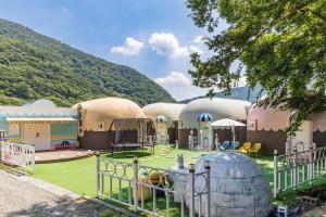 a building with a playground in front of it at Machupichu Pension in Miryang