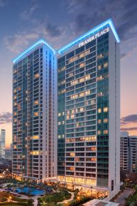 a large building with a clock on top of it at Fraser Place Setiabudi Jakarta in Jakarta