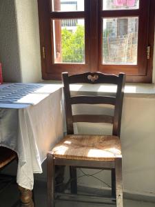 a wooden chair sitting at a table in front of a window at Home on the beach Vastadi in Mandrákion +31 photos