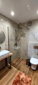 a bathroom with a shower and a sink and a toilet at Memories House in Edessa +15 photos