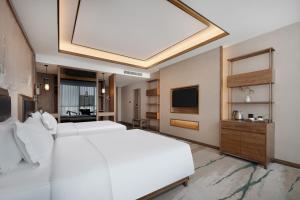 Ένα ή περισσότερα κρεβάτια σε δωμάτιο στο Grand Mercure Kunming South +60 φωτογραφίες