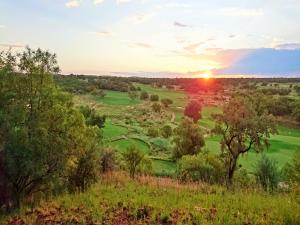 a view of a golf course at sunset at Elements Private Golf Reserve in Bela-Bela
