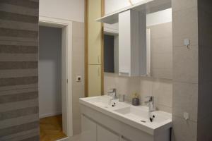 a bathroom with a white sink and a mirror at Oasis Premium Twin in Primošten +44 photos