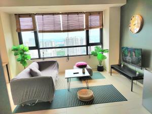 a living room with a couch and a television at F1-33-13 Sweet Home5,1BRTamarindWiFiNetflixFreeParking in Cyberjaya