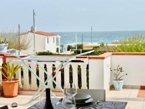 a table on a balcony with a view of the ocean at San Lorenzo Holiday in San Lorenzo