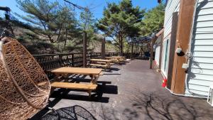 a row of wooden benches sitting on a patio at Namwon Along the Waterways of Jiri Mountain in Namwon