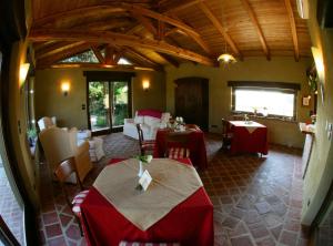 a restaurant with tables and chairs in a room at Le Soleil in Vigone