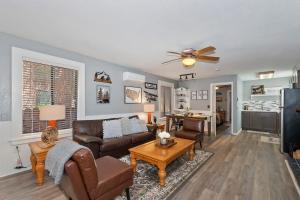 a living room with a couch and a table at Babbs Getaway Big Bear w Patio Balcony & Fireplace in Big Bear City
