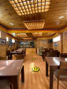 a restaurant with tables and chairs and a frisbee on the floor at Cozinn A104 in Leh