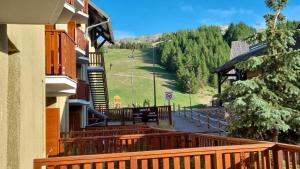 a balcony of a building with a view of a hill at P2 au pied des Pistes La Joue du Loup in Le Dévoluy