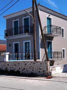 a large white building with balconies on a street at Liber-Mar apartments in Petra