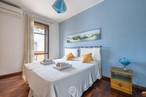 una camera da letto blu con un letto con asciugamani sopra di Casa Daniela a Pula