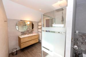 a bathroom with a sink and a mirror at Chez Watersy in Belle-et-Houllefort +32 photos