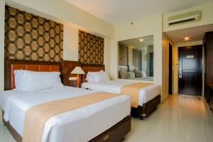 Letto o letti in una camera di Istana Nelayan Hotel & Convention Powered by Archipelago