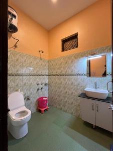 a bathroom with a toilet and a sink at Vacation home in Dharmsāla