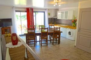 a kitchen and dining room with a table and chairs at Le Clos Saint Elme in Collioure +25 photos