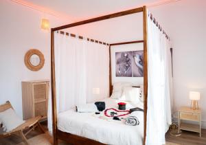 a bedroom with a canopy bed and a chair at L'Ecrin d'Albi - Love Room - 1 chambre in Albi
