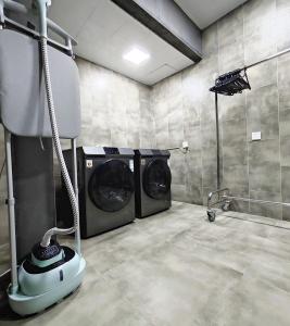 a laundry room with two washing machines in it at Cachet Boutique Kunming Artime in Kunming