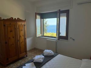a bedroom with a bed and a window at Villa Ubertina - Tricase Porto in Marina Porto