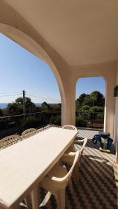 a white table and chairs on a patio at Villa Ubertina - Tricase Porto in Marina Porto