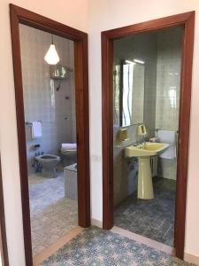 a bathroom with a sink and a toilet at Villa Ubertina - Tricase Porto in Marina Porto +40 photos