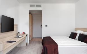 Postel nebo postele na pokoji v ubytování Hunguest Hotel Flóra