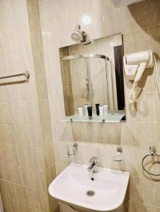 a bathroom with a sink and a mirror at tribu apart hotel in Bakuriani