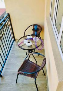 a glass table and a chair on a balcony at tribu apart hotel in Bakuriani +5 photos