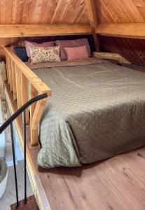 a bed in a room with a wooden ceiling at De Hooiberg in Made