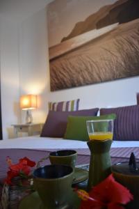 a table with cups and a glass of orange juice at Villa Jupe in Tías