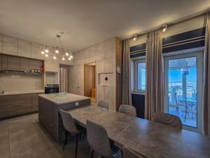 a kitchen with a large table and a large window at Luxury Boutique Property in Safed +12 photos