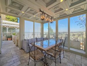 a dining room with a table and chairs and windows at Luxury Boutique Property in Safed
