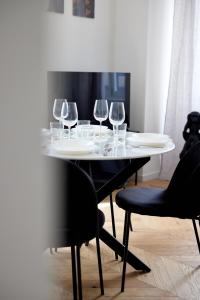 a table with wine glasses on top of it at Duomo Imperial Suits - Modern and comfortable in Milan