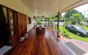 a porch of a house with a car parked at Villa ASIA in Nosy Be