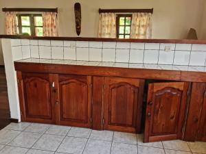 a kitchen with wooden cabinets and a counter top at Villa ASIA in Nosy Be