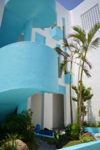 a blue building with palm trees in front of it at Coco Villa 2 in Cu Lao Thu